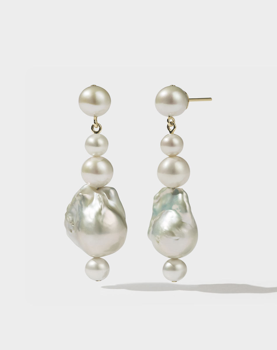 Gold drop earrings featuring a series of round and baroque freshwater pearls.