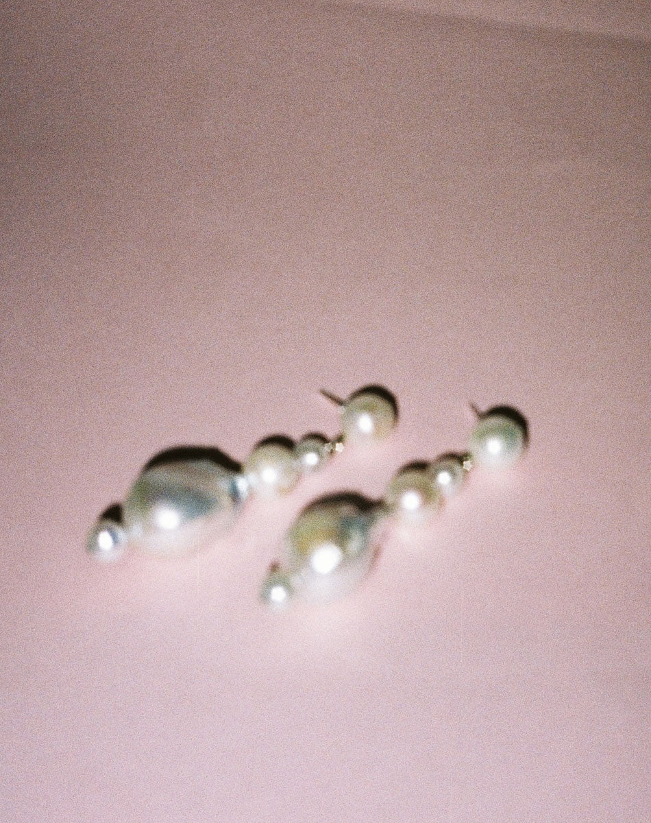 Pearl earrings featuring a series of round and baroque pearls