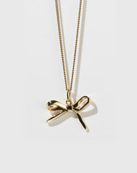Gold bow charm necklace with a fine chain