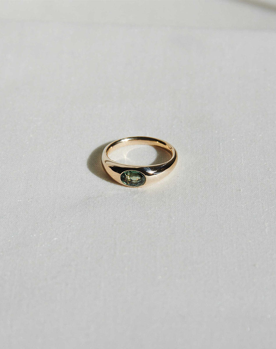Claude Platinum Ring with oval stone in Swiss setting, minimalist design detail.