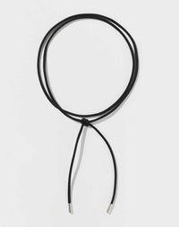 A black fabric cord necklace with metal tips.
