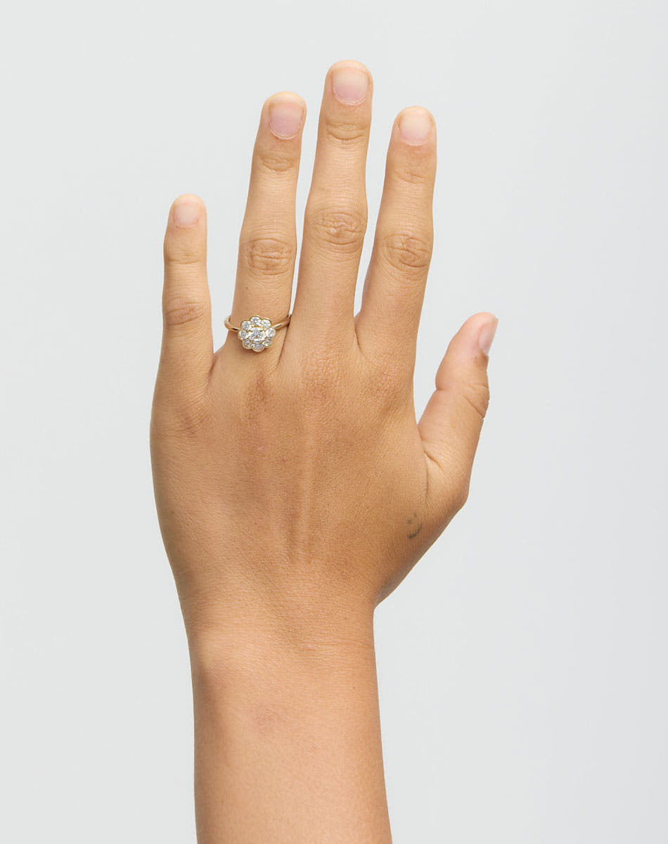 Hand wearing diamond ring on white background
