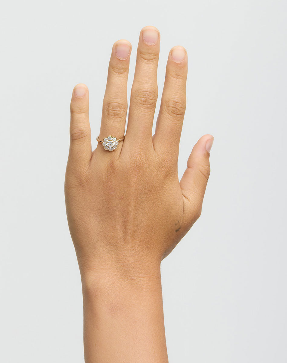 Hand wearing diamond ring on white background
