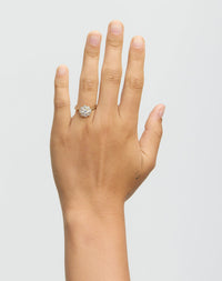Hand wearing diamond ring on white background
