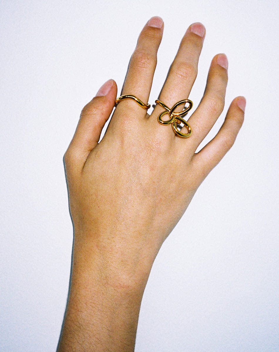 Gold rings on hand, flower ring, twisted halo band