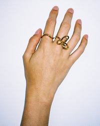 Gold rings on hand, flower ring, twisted halo band