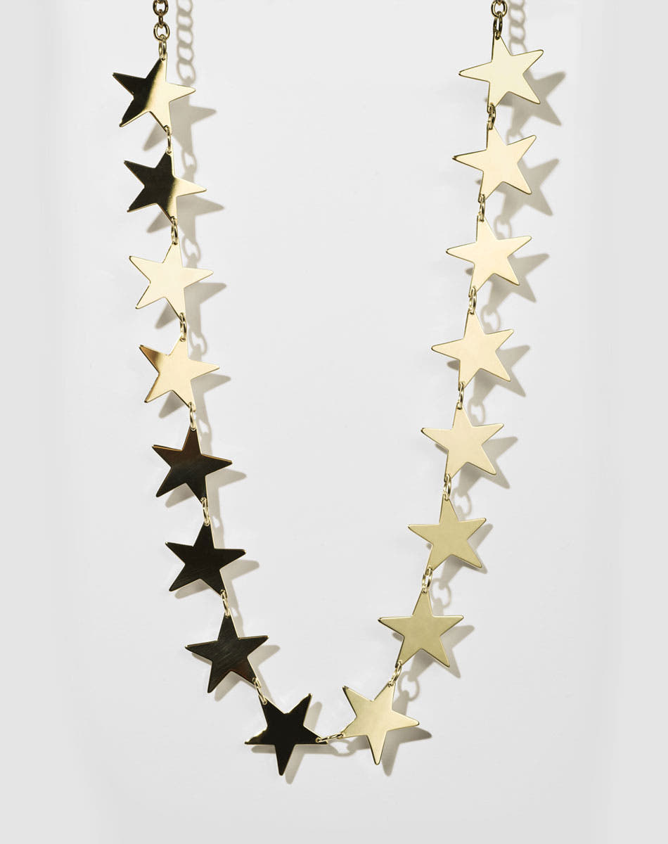 A gold necklace with a series of star-shaped charms linked together.