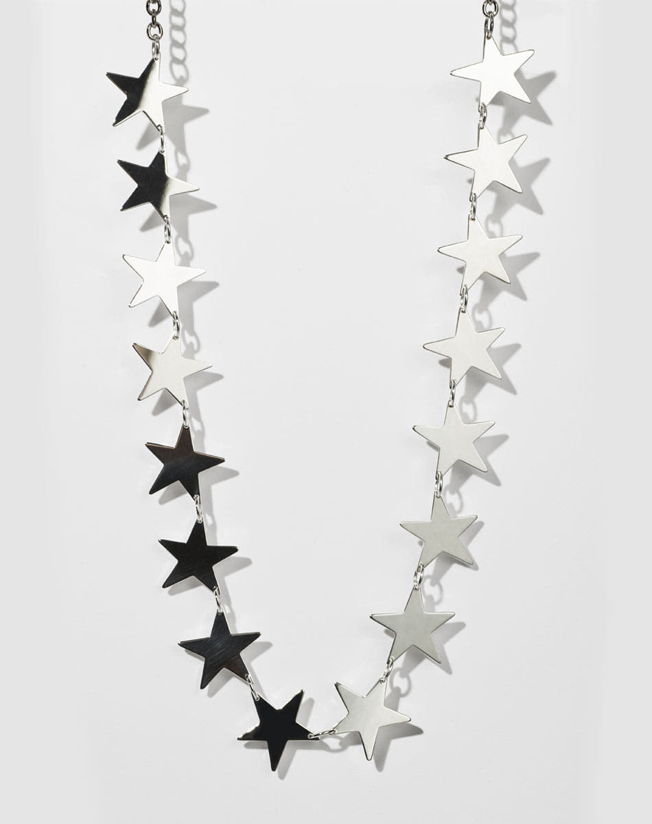 A sterling silver necklace with a series of star-shaped charms linked together.