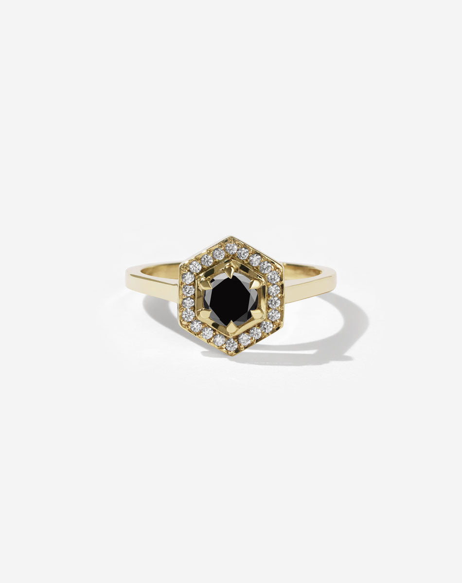 Meadowlark Jewellery’s iconic Hex Engagement Ring 0.5ct in 14ct Yellow Gold, claw set with 0.61ct round brilliant cut black diamond centre stone, surrounded by a hexagon halo of pave set white diamonds. One of our most beloved and modern Ceremonial designs, made to order in New Zealand. Pair with our bestseller, the Diamond Eternity Band.