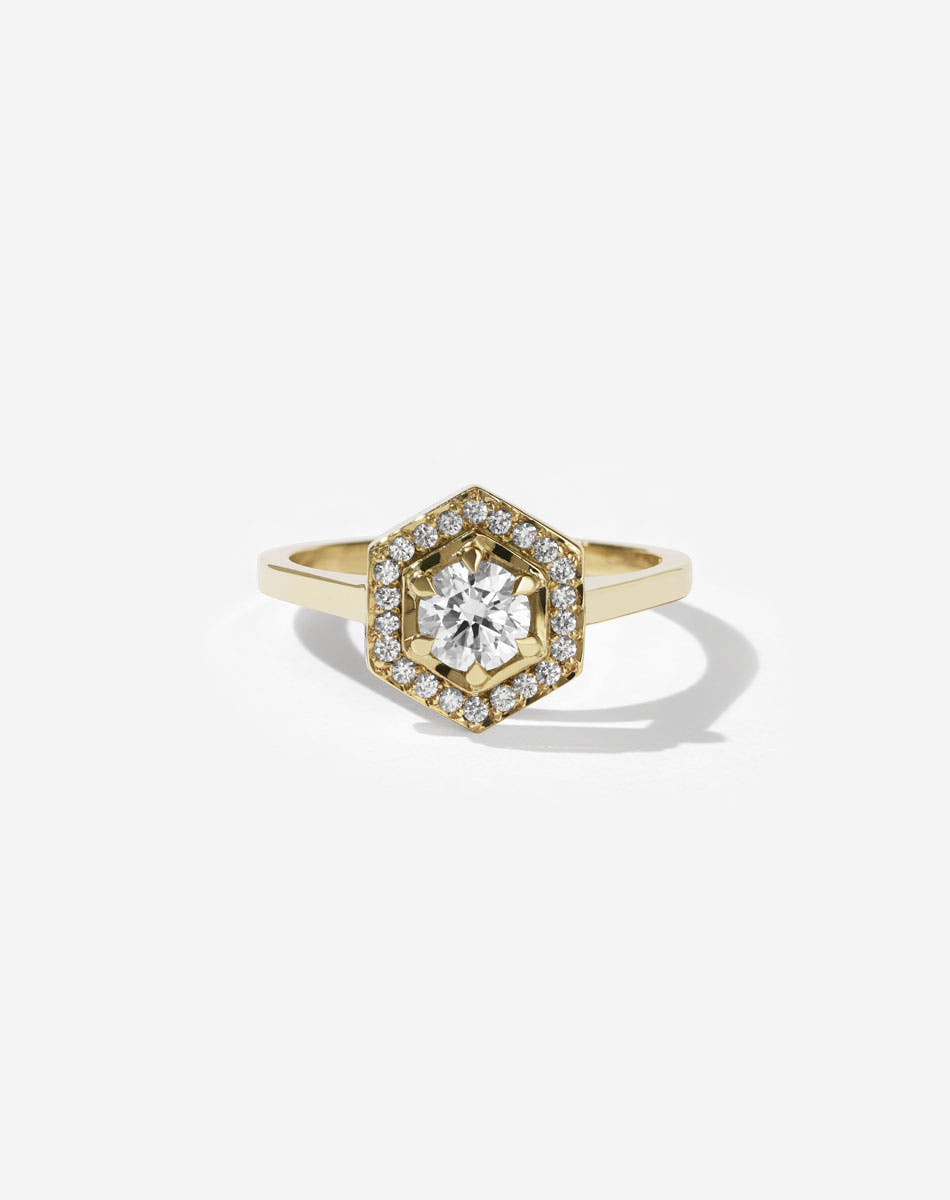Meadowlark Jewellery’s iconic Hex Engagement Ring 0.5ct in 14ct Yellow Gold, claw set with 0.61ct round brilliant cut white diamond centre stone, surrounded by a hexagon halo of pave set white diamonds. One of our most beloved and modern Ceremonial designs, made to order in New Zealand. Pair with our bestseller, the Diamond Eternity Band.
