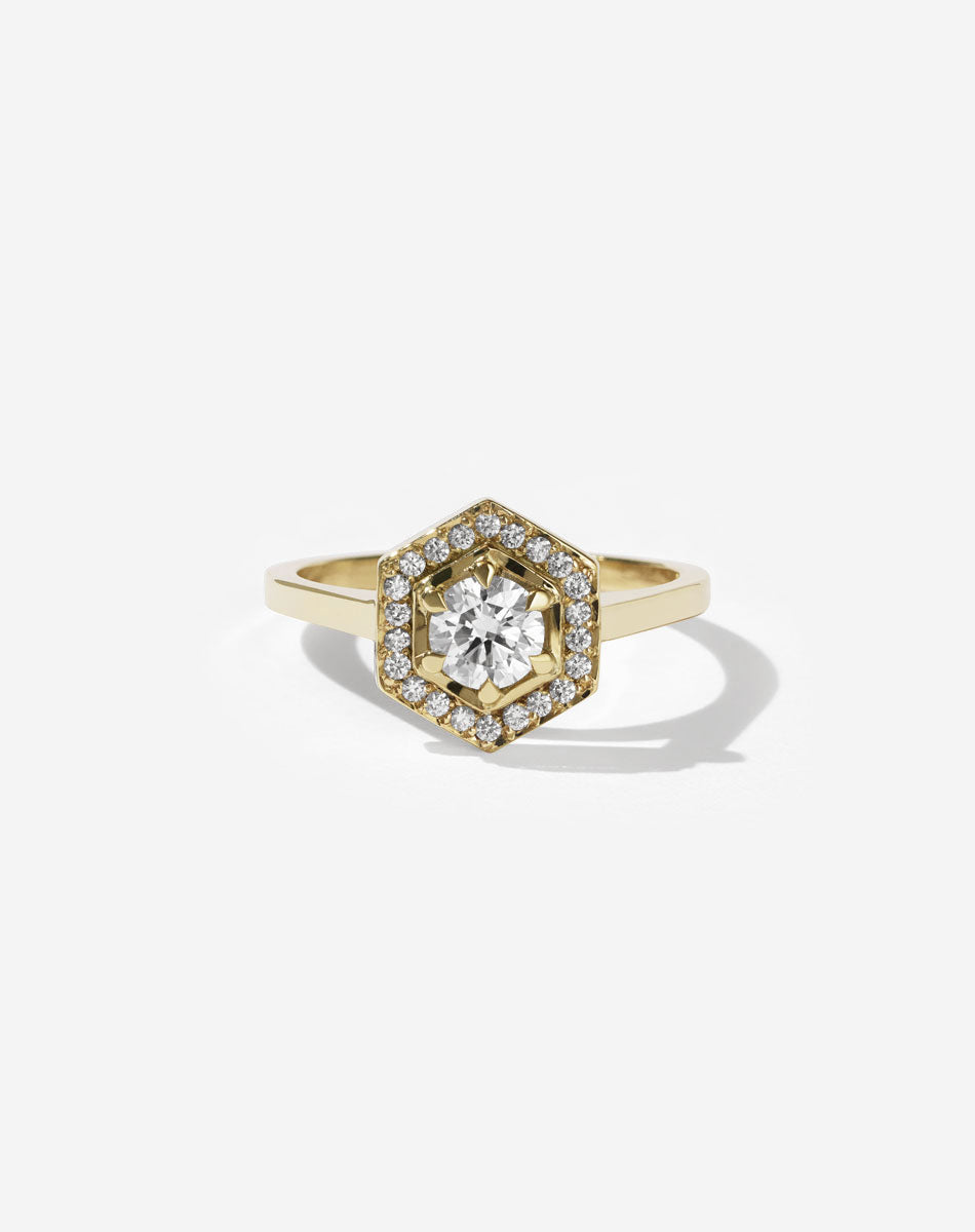 Meadowlark Jewellery’s iconic Hex Engagement Ring 0.5ct in 14ct Yellow Gold, claw set with 0.61ct round brilliant cut white diamond centre stone, surrounded by a hexagon halo of pave set white diamonds. One of our most beloved and modern Ceremonial designs, made to order in New Zealand. Pair with our bestseller, the Diamond Eternity Band.