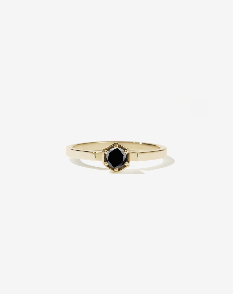 Meadowlark Jewellery’s classic Hexagon Solitaire Engagement Ring in 14ct Yellow Gold, claw set with a 0.25ct round brilliant cut black diamond atop a fine square band. A minimalist, yet bold Ceremonial design made to order in New Zealand.