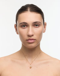 Woman wearing a gold bunny rabbit charm necklace
