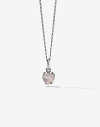 Necklace with a heart-shaped pink rose quartz stone pendant on a light gray background