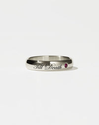 A 14ct white gold band ring with the phrase 'Till Death' engraved on it and a single ruby set in a white gold band.