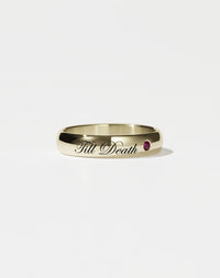 A 14ct yellow gold band ring with the phrase 'Till Death' engraved on it and a single ruby set in a white gold mounting.