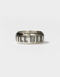 A white gold band ring with the phrase 'Till Death' engraved on it and set with white diamonds.