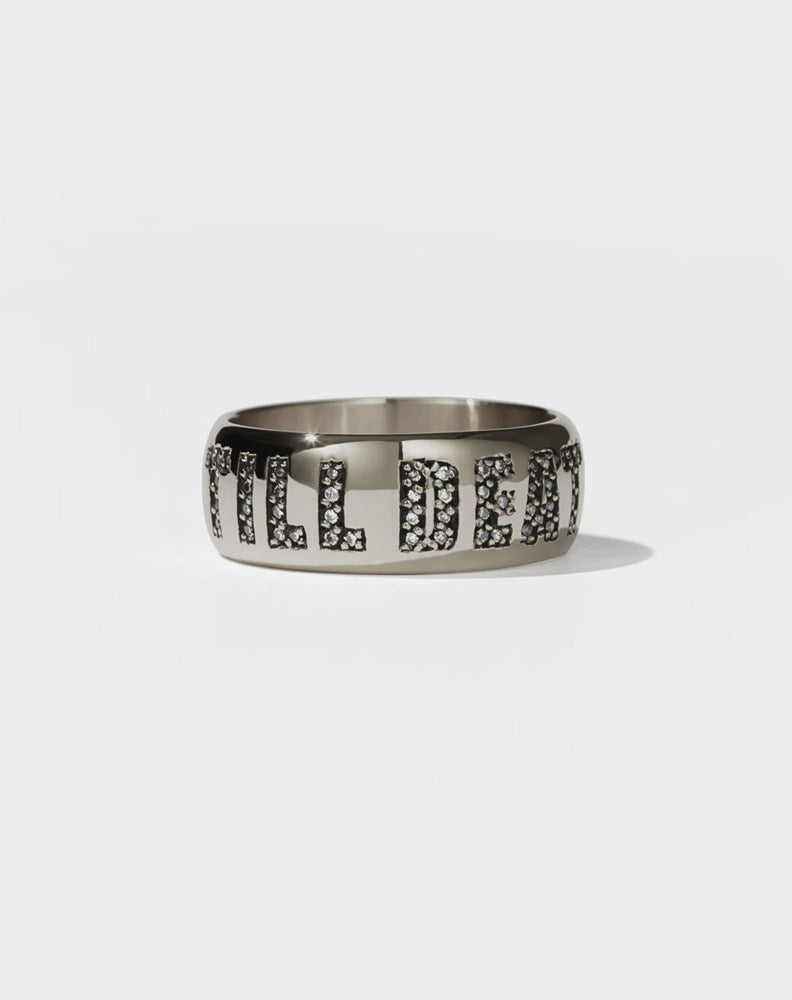 A white gold band ring with the phrase 'Till Death' engraved on it and set with white diamonds.