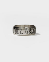 A white gold band ring with the phrase 'Till Death' engraved on it and set with white diamonds.