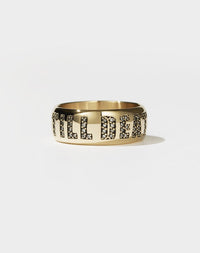 A yellow gold band ring with the phrase 'Till Death' engraved on it and set with white diamonds.