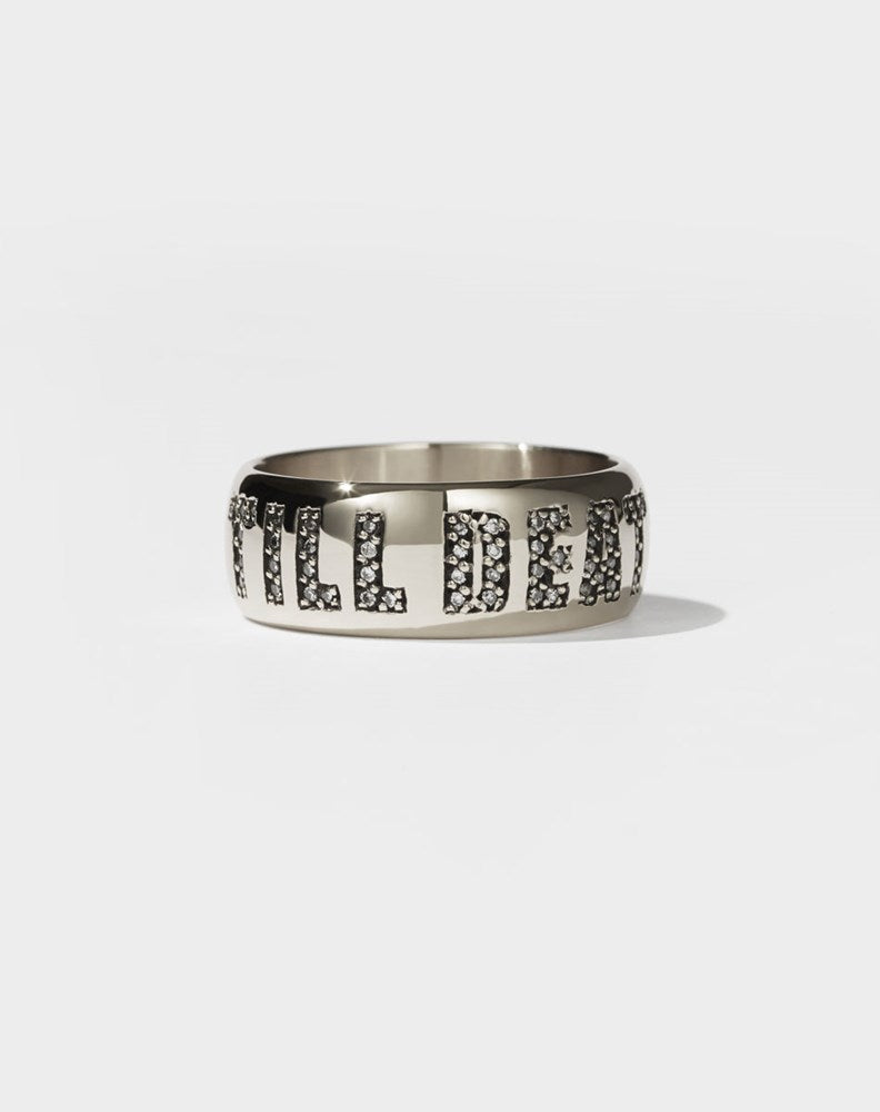 A white gold band ring with the phrase 'Till Death' engraved on it and set with white diamonds.