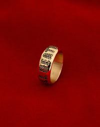 A yellow gold band ring with the phrase 'Till Death' engraved on it and set with white diamonds.