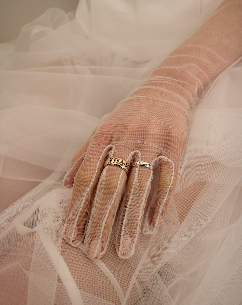 Wedding bands with the phrase 'Till Death' engraved with and without diamonds. On a hand.