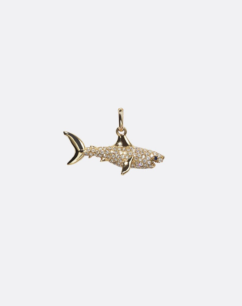 Gold shark pendant with embedded diamonds on a white background