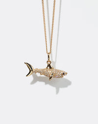 Gold shark pendant set with diamonds necklace on a white background