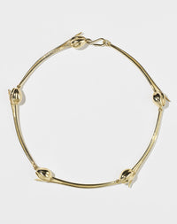 Gold necklace with tulip designs on a white background