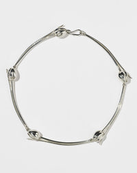 Silver tulip motif necklace on a white background