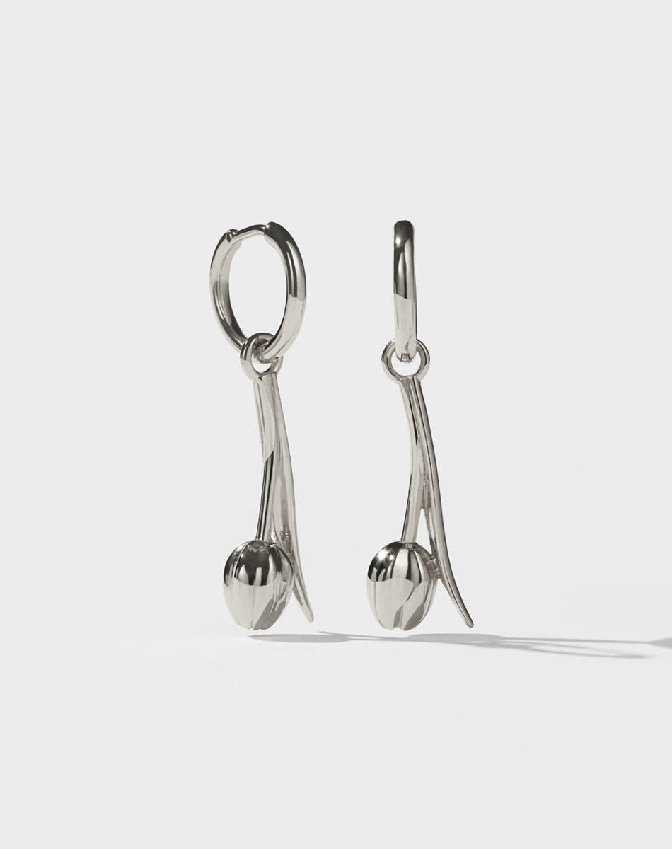 Pair of silver tulip motif earrings on a white background