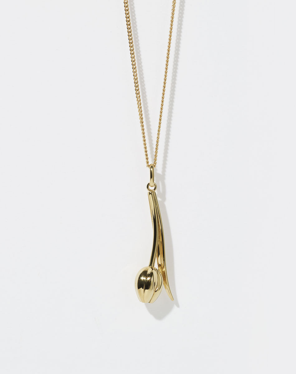 Gold Tulip motif necklace on a white background
