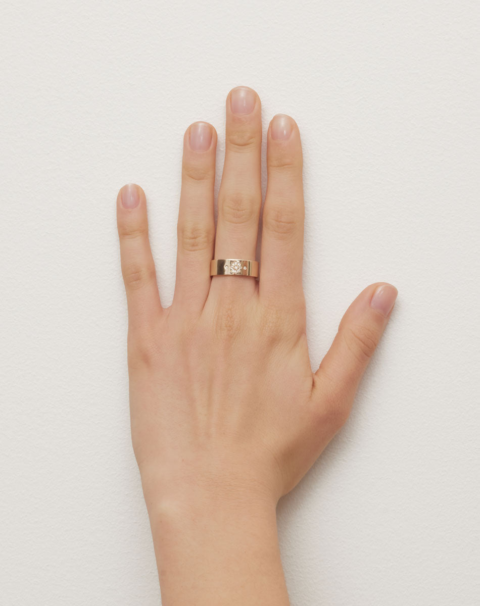 Violet Ring with floral engraving in 9ct Yellow Gold. Set with round brilliant cut White Diamond. 6.4mm width wedding band. Worn on model hand.
