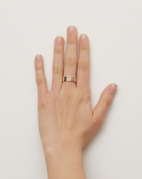 Violet Ring with floral engraving in 9ct Yellow Gold. Set with round brilliant cut White Diamond. 6.4mm width wedding band. Worn on model hand.
