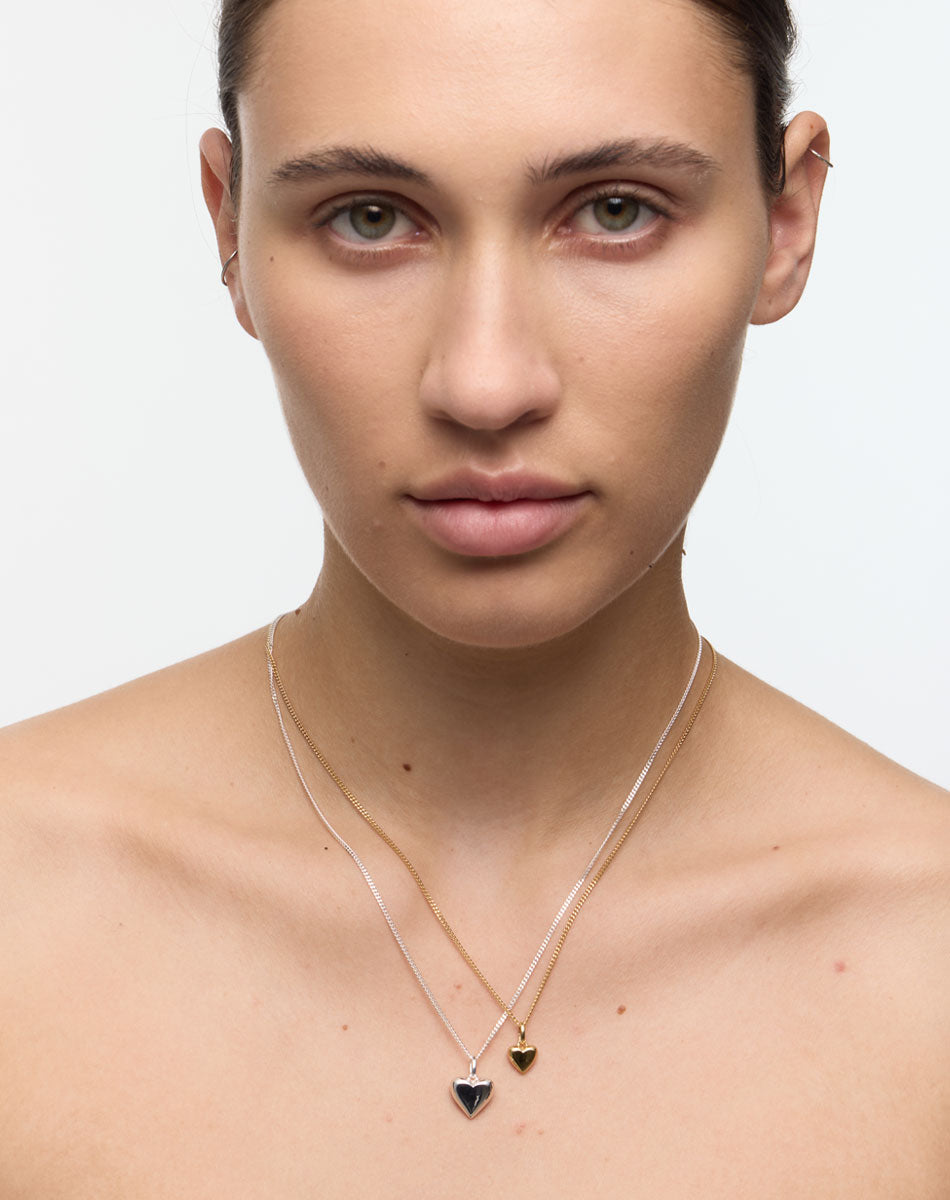 Woman wearing a necklace with a heart-shaped pendants