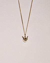 Gold charm necklace with a cat head pendant 
