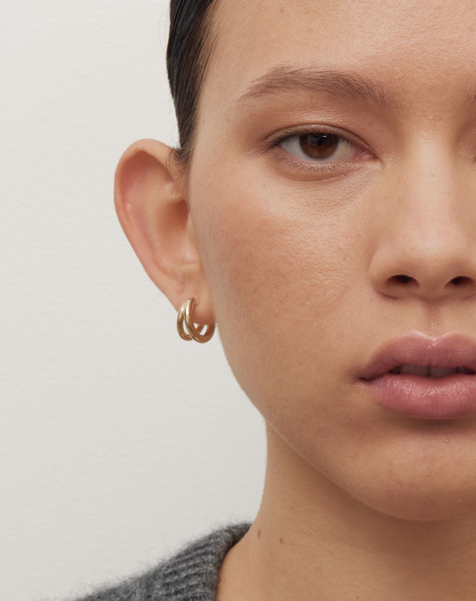 Coco Hoops Medium Earrings in 23k Gold Plated or 9ct Yellow Gold, featuring a double hoop and lever or clicker back earring closure. Inner diameter approximately 10mm. Worn on model. 