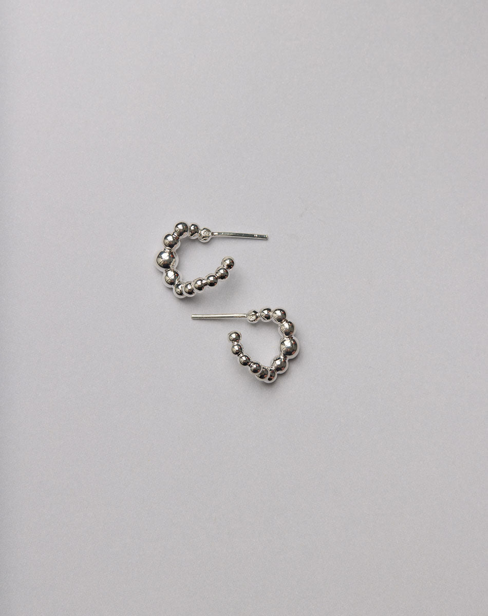 Pair of silver hoop earrings made from a series of bubbly balls