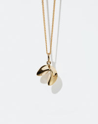 Gold necklace with a fortune cookie shaped pendant on a white background