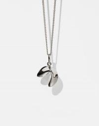 Silver necklace with fortune cookie shaped pendant on a white background