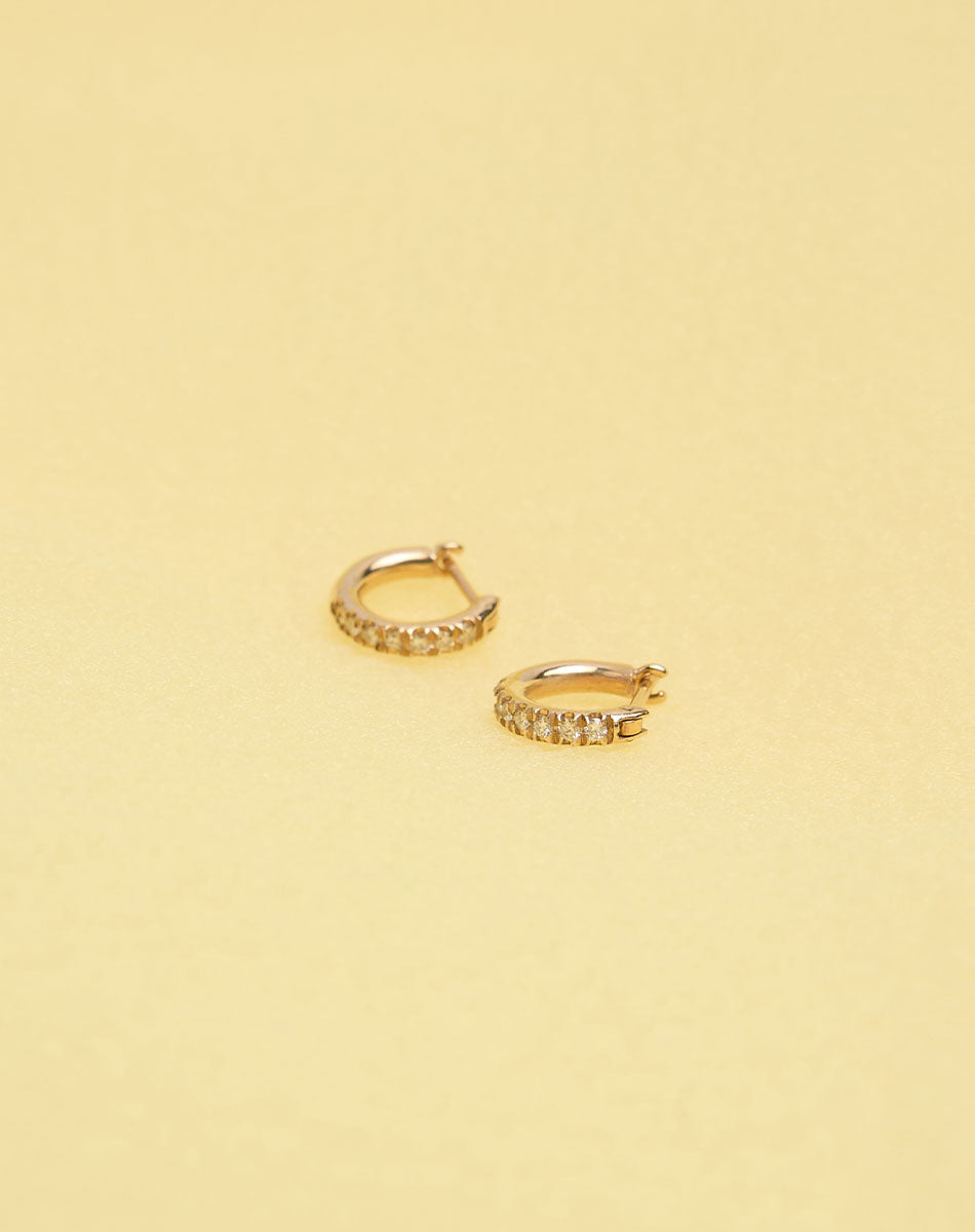 Halo Huggies Pave Earring in 9ct Yellow Gold with round brilliant cut, French pave set white diamonds. Featuring a lever or clicker back earring closure. Inner diameter approximately 7mm.