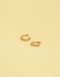 Halo Huggies Pave Earring in 9ct Yellow Gold with round brilliant cut, French pave set white diamonds. Featuring a lever or clicker back earring closure. Inner diameter approximately 7mm.