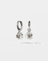 Silver four leaf clover shaped earrings on a white background