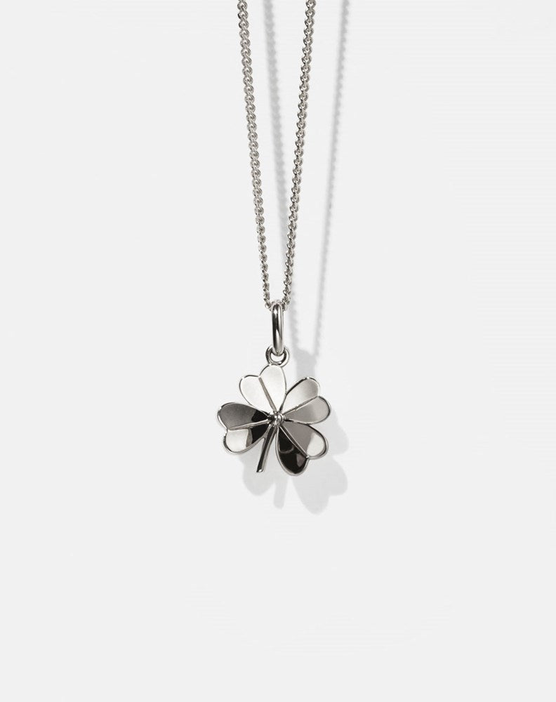 Silver necklace with a four-leaf clover pendant on a white background