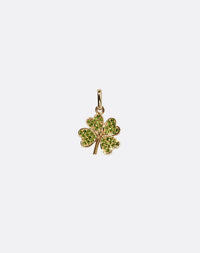 Gold four-leaf clover charm set with green gemstones on a white background