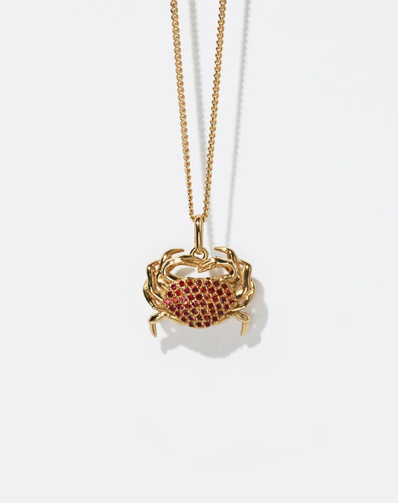 Gold crab-shaped pendant necklace with red stones 