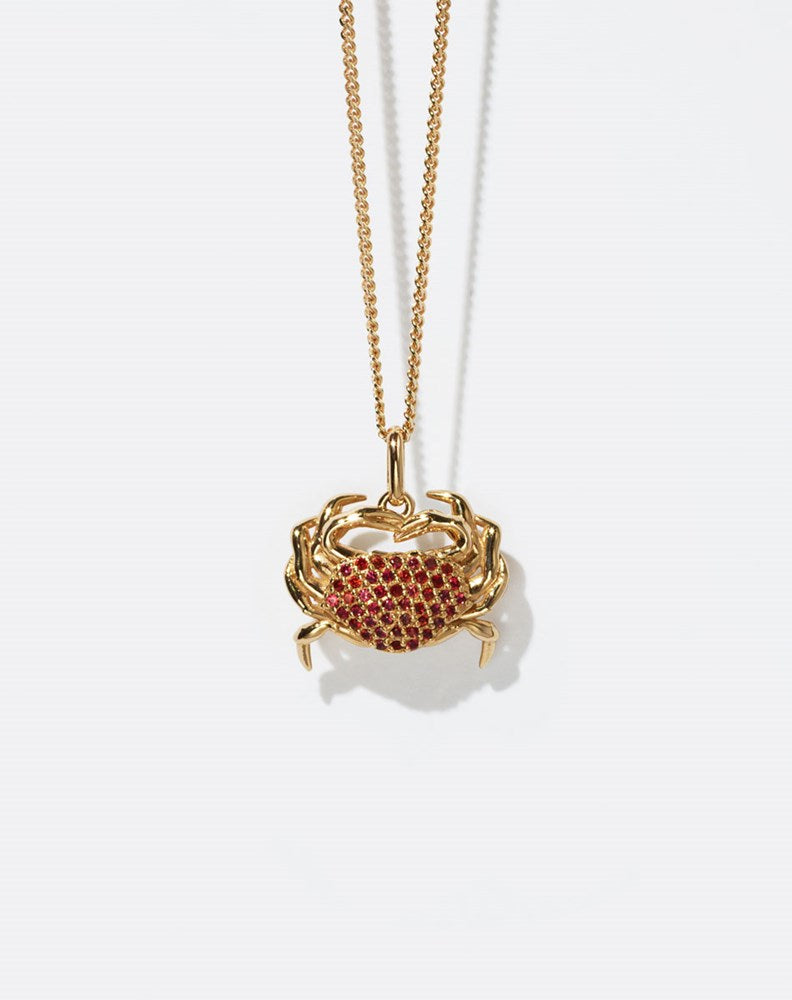 Gold crab-shaped pendant necklace with red stones 