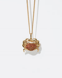 Gold crab-shaped pendant necklace with red stones 