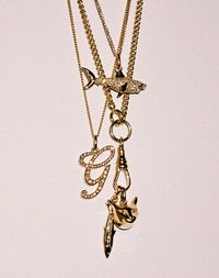 Layered Gold charm necklaces with diamonds. Shark charm,  cat charm,  sardine charm.
